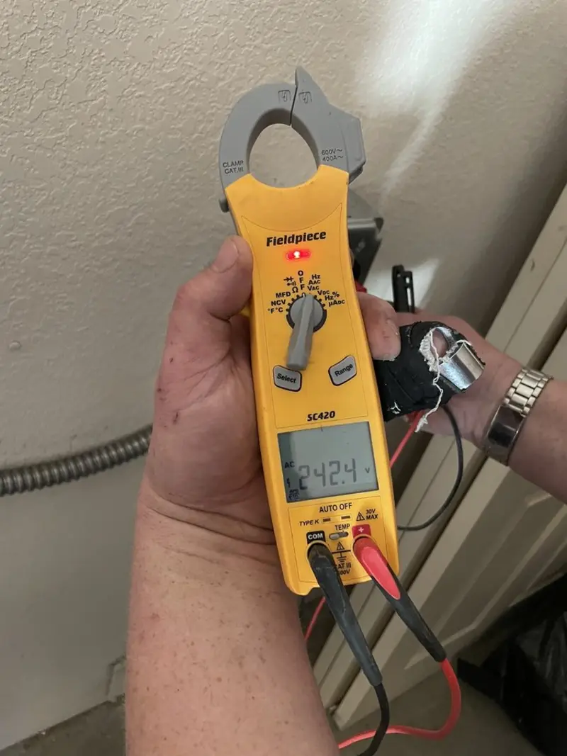 Voltage testing with clamp meter during Recessed Lighting Installation in East Porterville